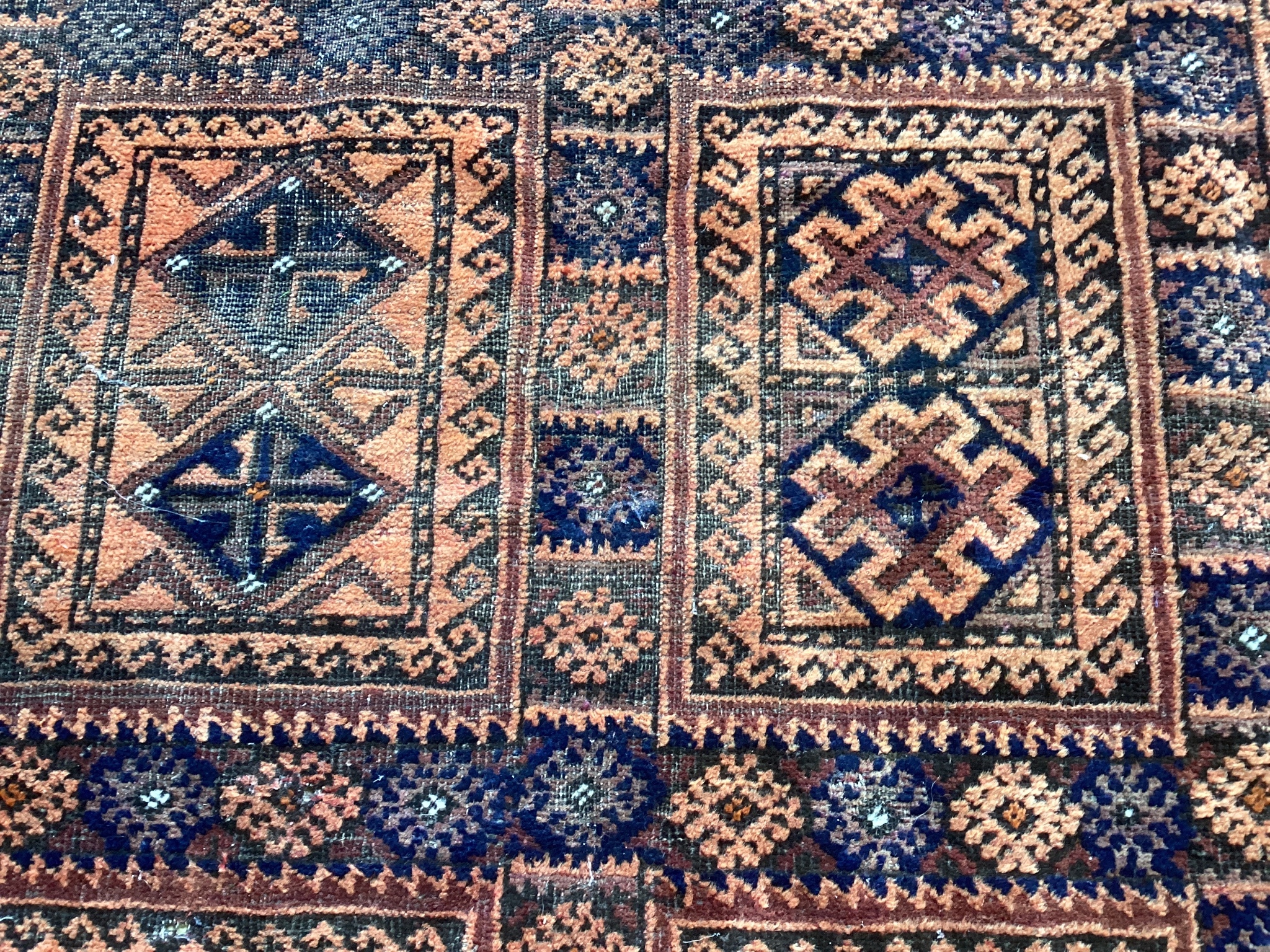 A Belouch blue ground geometric rug 240cm x 140cm